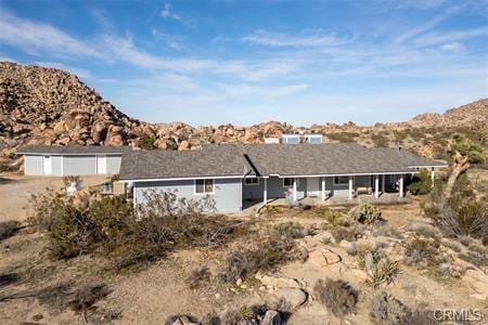 back of property featuring a mountain view