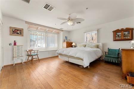 bedroom featuring visible vents and wood finished floors