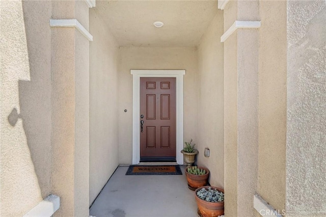 doorway to property with stucco siding