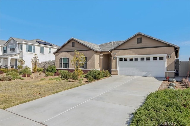 ranch-style house featuring a front yard, concrete driveway, an attached garage, and stucco siding