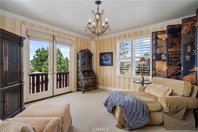 living area with carpet flooring, french doors, ornamental molding, wallpapered walls, and an inviting chandelier