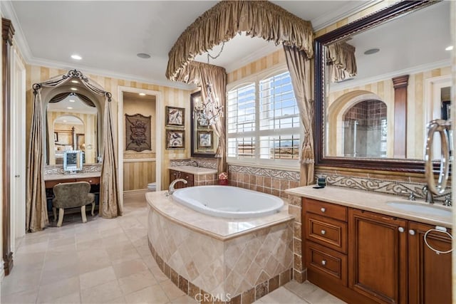 bathroom featuring a garden tub, toilet, vanity, tile patterned floors, and crown molding