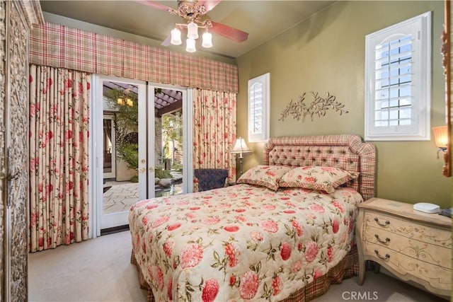 bedroom featuring access to exterior, french doors, light carpet, and a ceiling fan