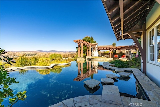 view of pool featuring a patio area, a mountain view, and a pergola