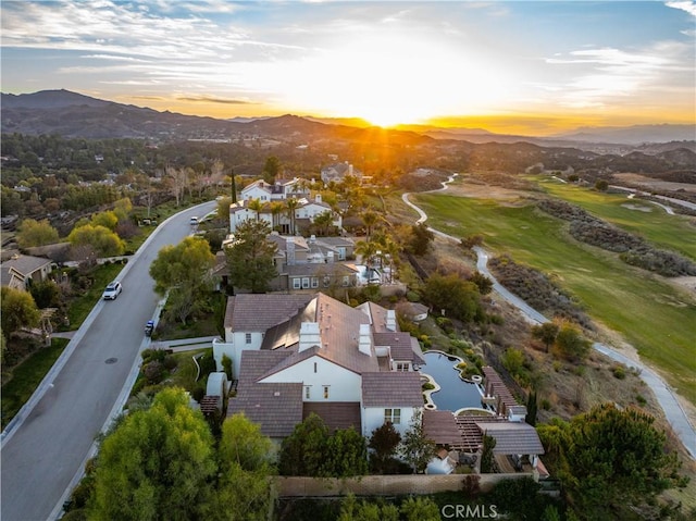 aerial view at dusk featuring a residential view and a mountain view