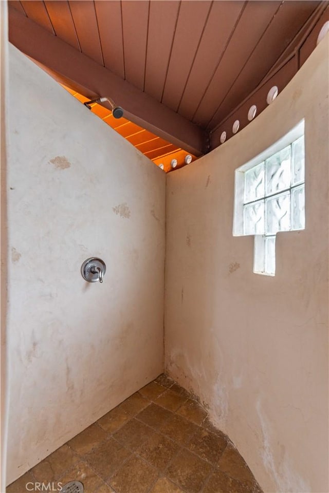 interior space featuring wooden ceiling and stone finish floor