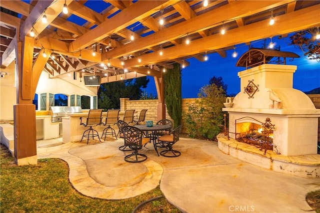 view of patio featuring a large fireplace and a pergola