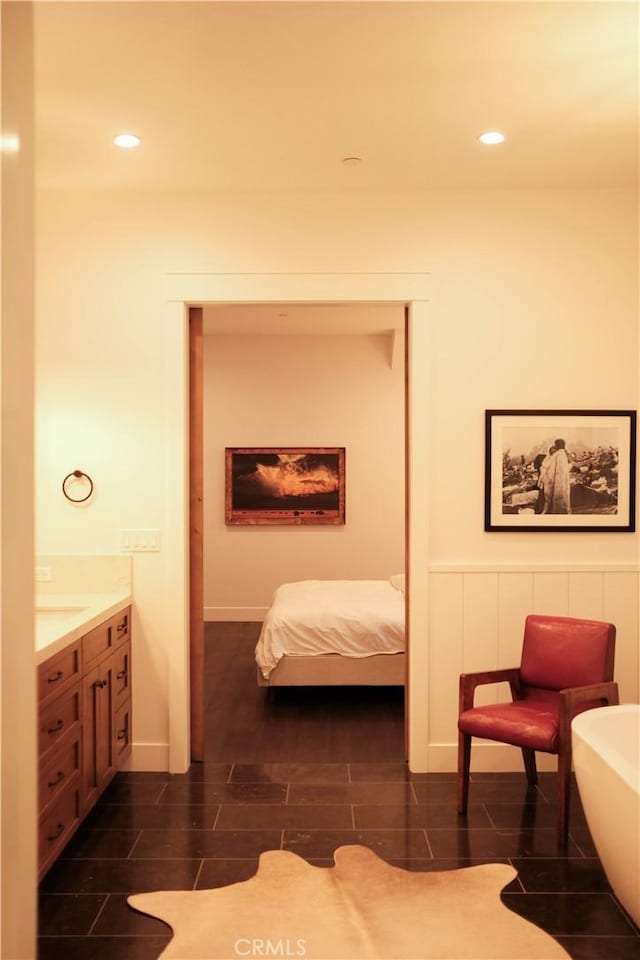 bedroom with recessed lighting and wood finish floors