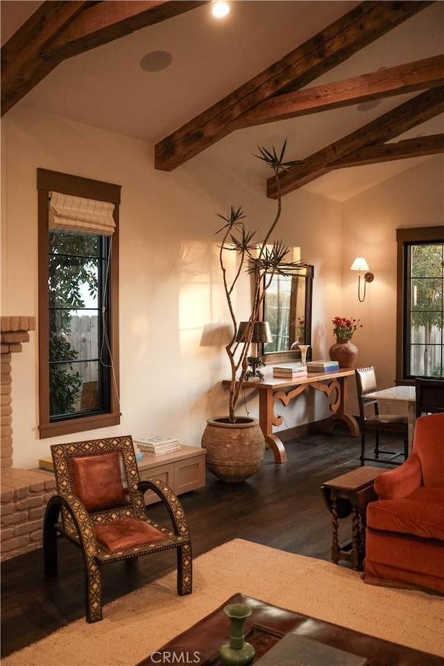 living area featuring vaulted ceiling with beams and wood finished floors