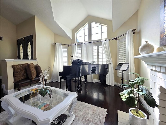 interior space with lofted ceiling, dark wood-style flooring, visible vents, and baseboards