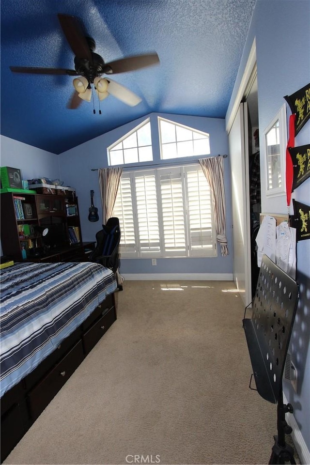 bedroom featuring a textured ceiling, lofted ceiling, carpet floors, baseboards, and a closet