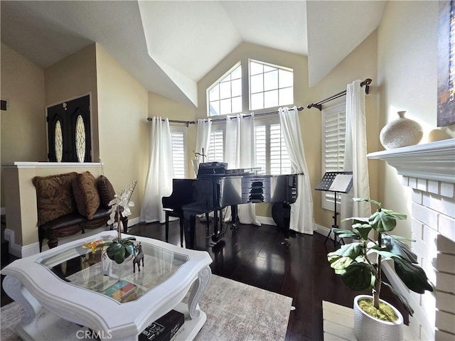 interior space featuring visible vents, baseboards, vaulted ceiling, and dark wood-type flooring