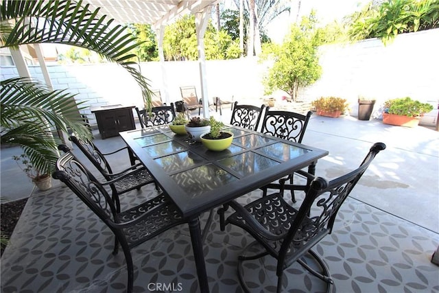 view of patio featuring a fenced backyard, a pergola, and outdoor dining space