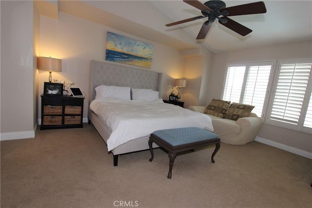 bedroom with lofted ceiling, ceiling fan, baseboards, and light colored carpet