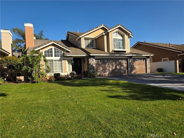 view of front facade featuring a garage, aphalt driveway, and a front lawn