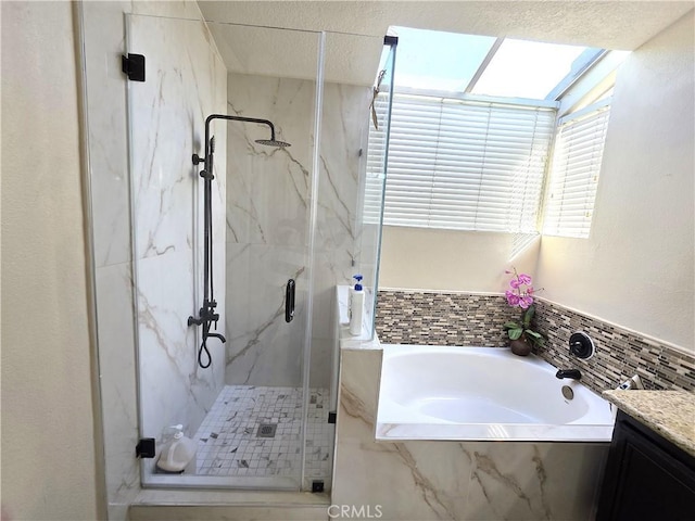 full bath with a garden tub, vanity, and a marble finish shower