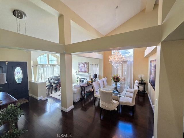 dining room with high vaulted ceiling, a fireplace, dark wood finished floors, and baseboards