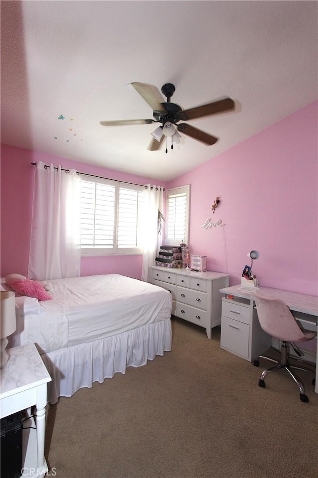 bedroom with a ceiling fan and dark colored carpet