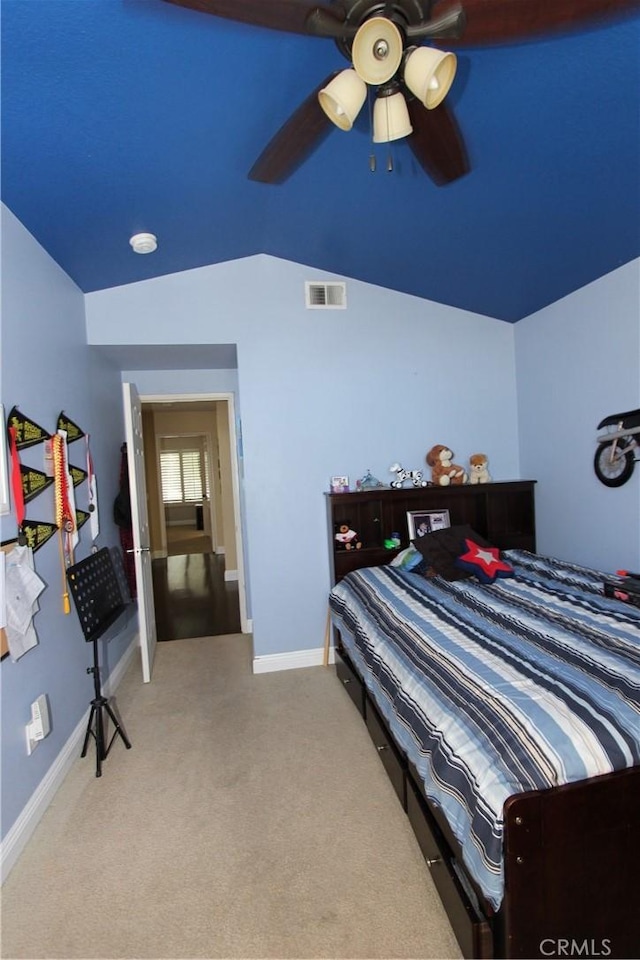 bedroom with light colored carpet, visible vents, a ceiling fan, vaulted ceiling, and baseboards