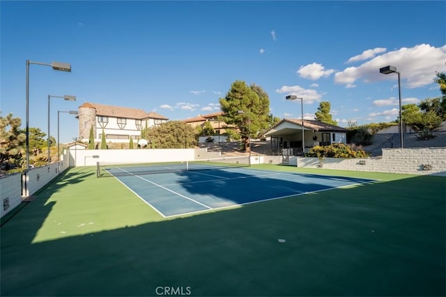 view of sport court featuring fence