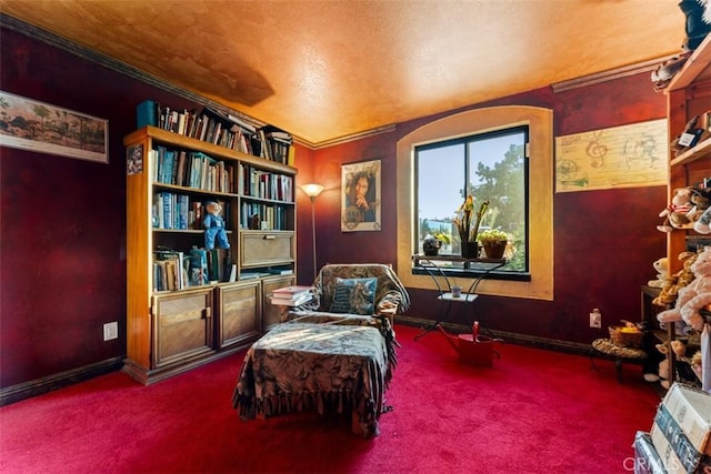 living area with carpet floors, ornamental molding, and baseboards