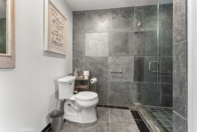 full bathroom with a shower stall, toilet, and tile patterned floors