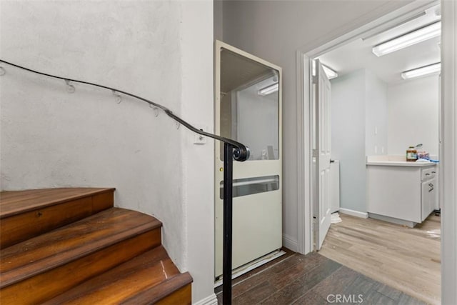 staircase with wood finished floors