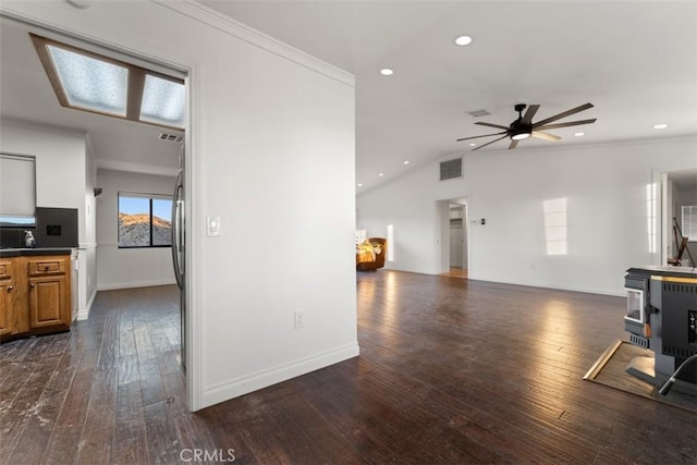 living area with lofted ceiling, recessed lighting, visible vents, ornamental molding, and dark wood-style floors