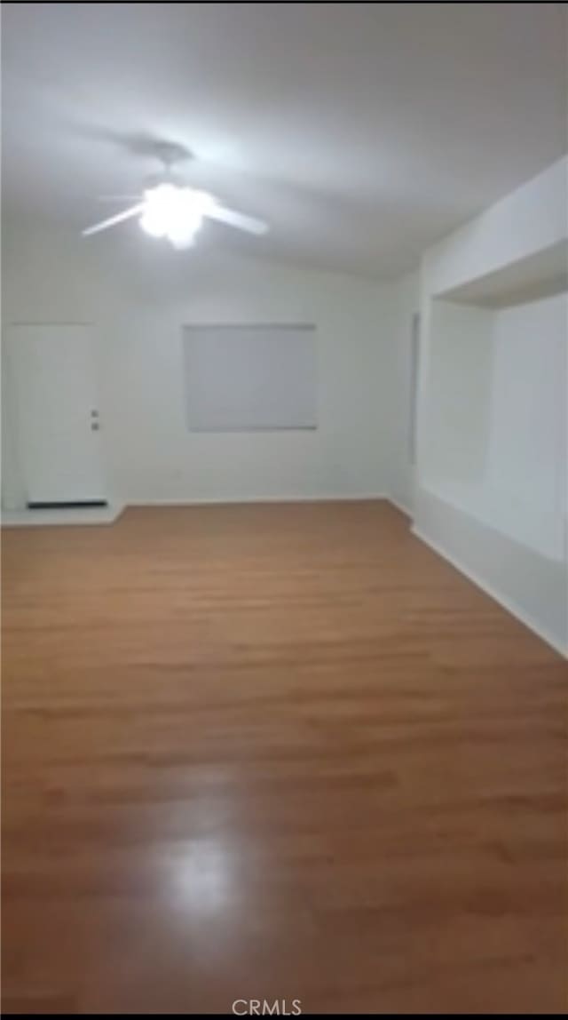 spare room with wood finished floors