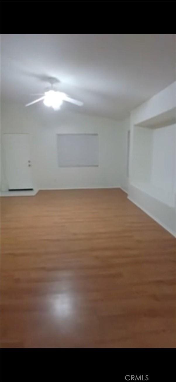 spare room with wood finished floors