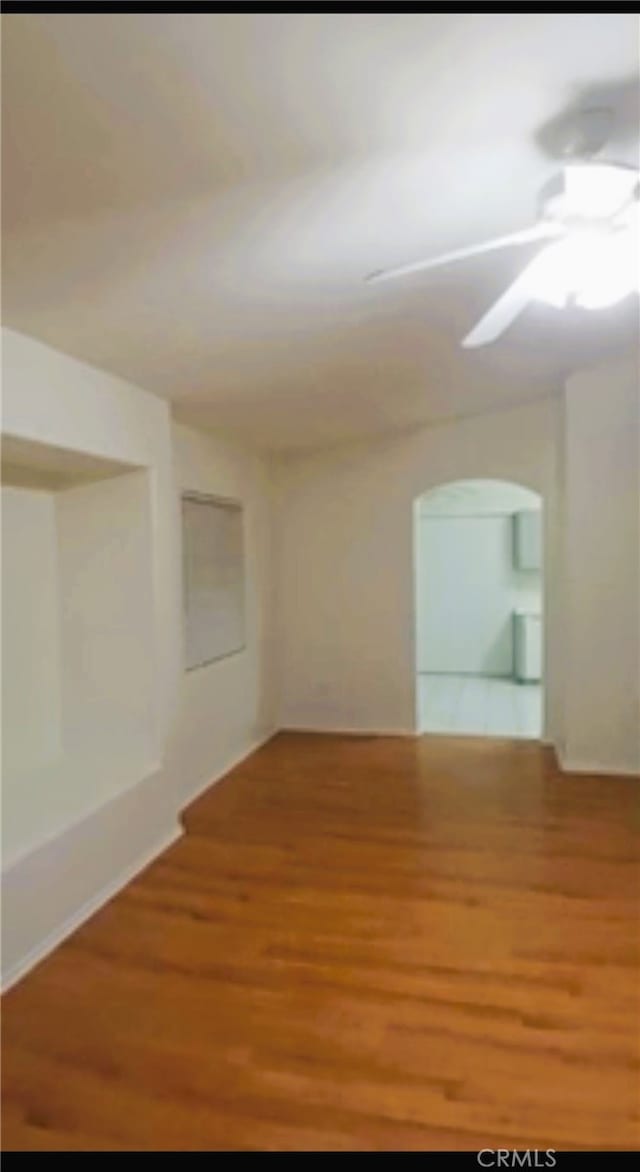 empty room featuring wood finished floors and a ceiling fan