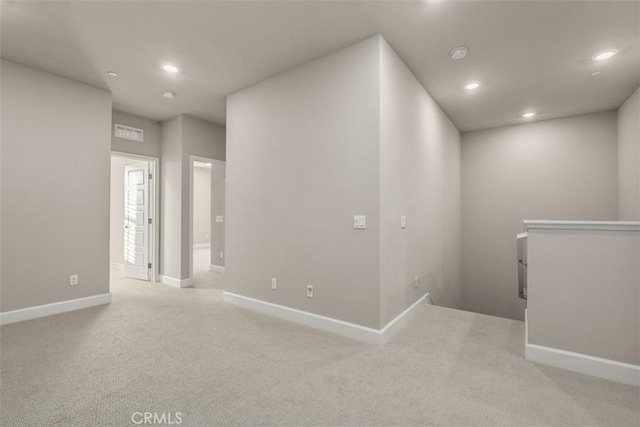 interior space with light carpet, baseboards, visible vents, and recessed lighting