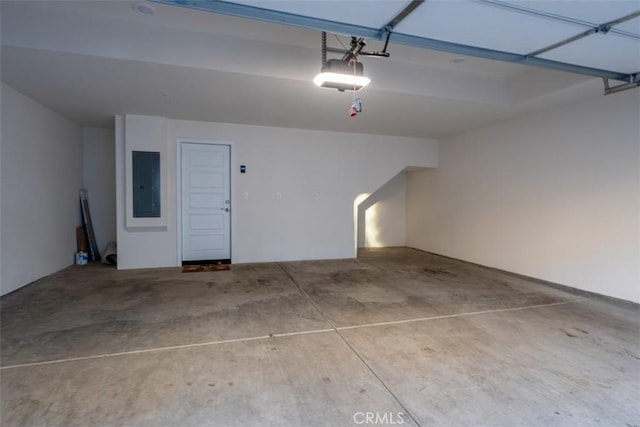 garage featuring electric panel and a garage door opener