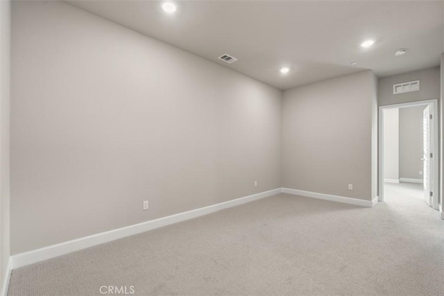 unfurnished room with light carpet, baseboards, visible vents, and recessed lighting