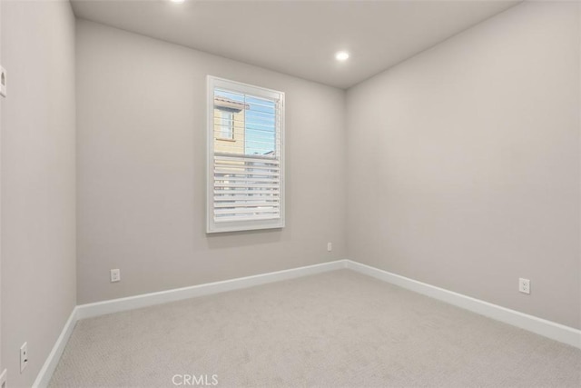 unfurnished room with carpet floors, recessed lighting, and baseboards