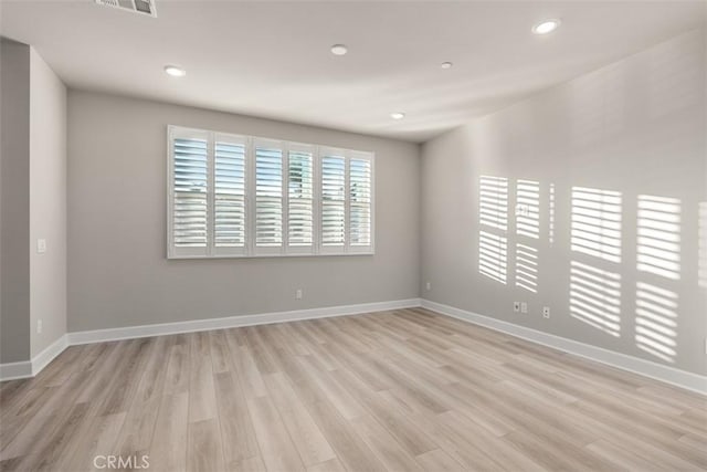 unfurnished room featuring recessed lighting, baseboards, visible vents, and light wood finished floors