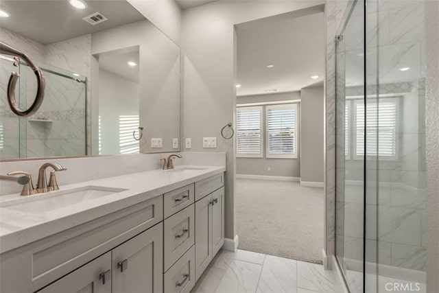 bathroom featuring double vanity, a marble finish shower, visible vents, and a sink