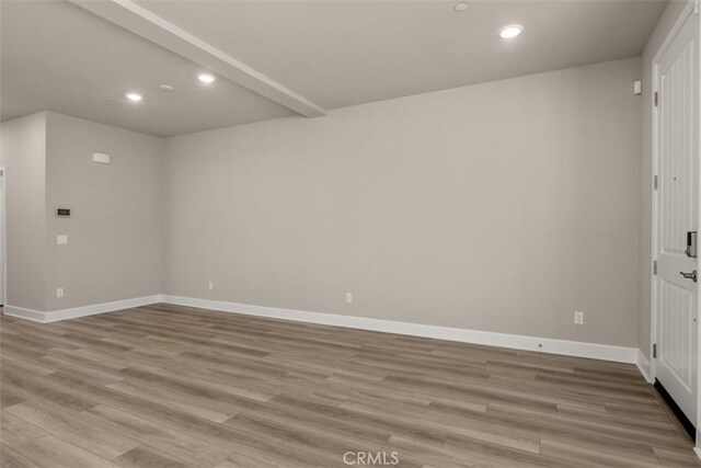 unfurnished room featuring baseboards, recessed lighting, and light wood-style floors