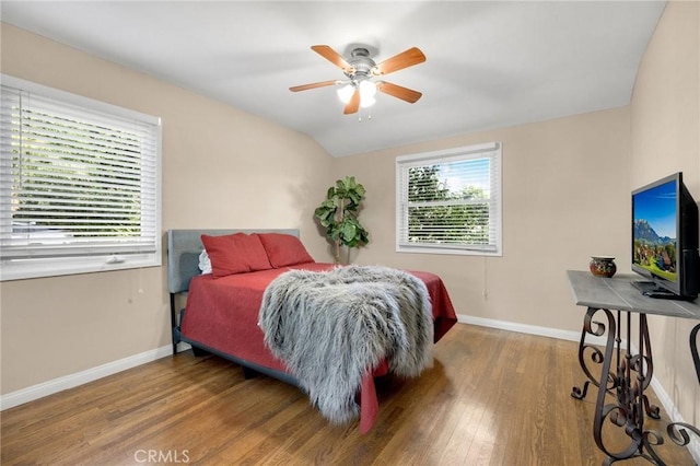 bedroom featuring lofted ceiling, ceiling fan, baseboards, and wood finished floors