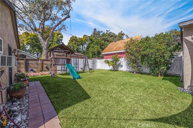 view of yard with a playground and a fenced backyard