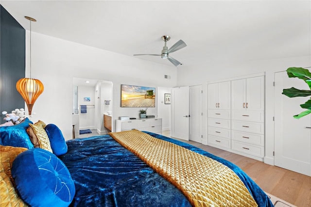 bedroom with baseboards, ensuite bathroom, a ceiling fan, and light wood finished floors