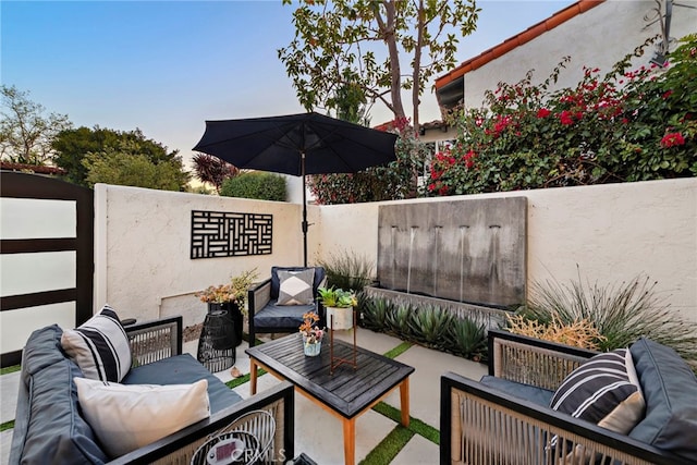 view of patio / terrace featuring outdoor lounge area and fence