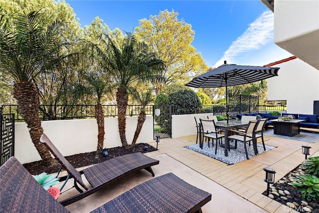 view of patio / terrace with an outdoor hangout area, outdoor dining space, and fence