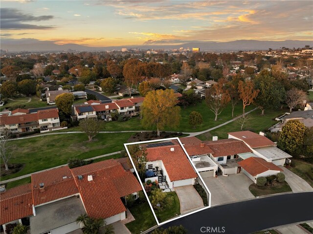 aerial view at dusk featuring a residential view