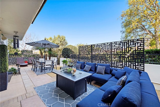 view of patio / terrace with an outdoor hangout area and fence