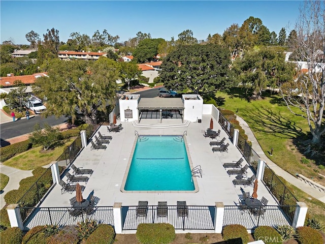 community pool featuring a patio and fence