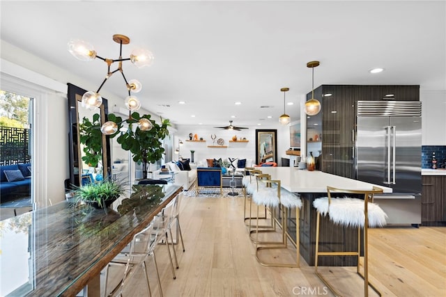 kitchen featuring light wood finished floors, built in refrigerator, light countertops, and modern cabinets