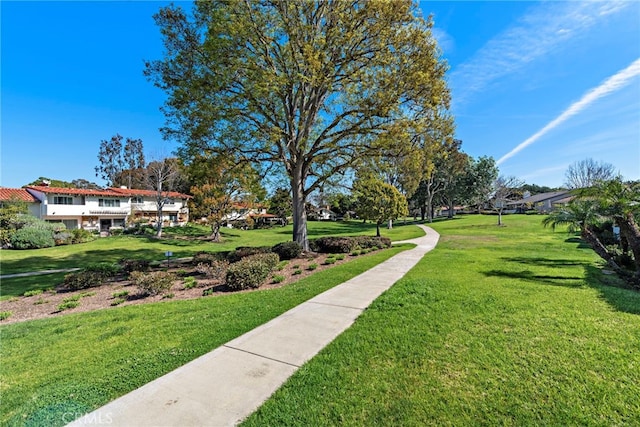 view of home's community featuring a lawn