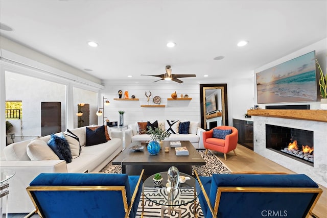 living room featuring wood finished floors, recessed lighting, and a high end fireplace