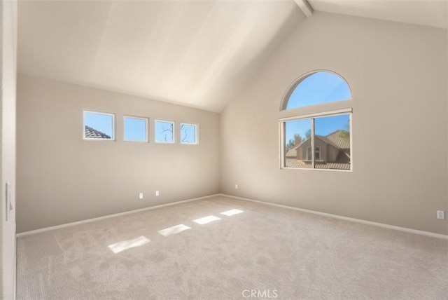 carpeted spare room featuring baseboards, high vaulted ceiling, and beamed ceiling